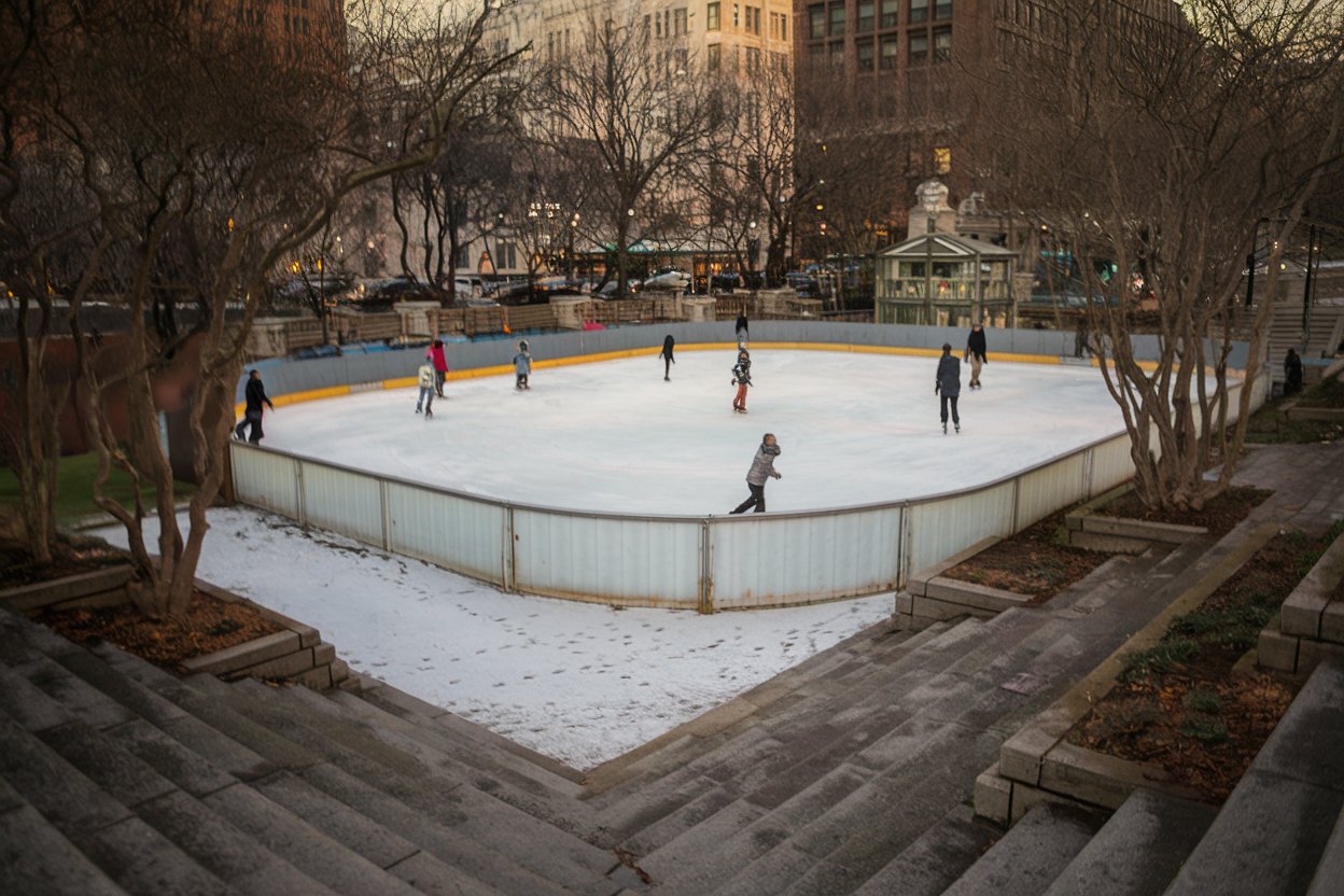 A festive ice skating rink in Washington, D.C., surrounded by twinkling holiday lights and cheerful skaters enjoying the winter season.