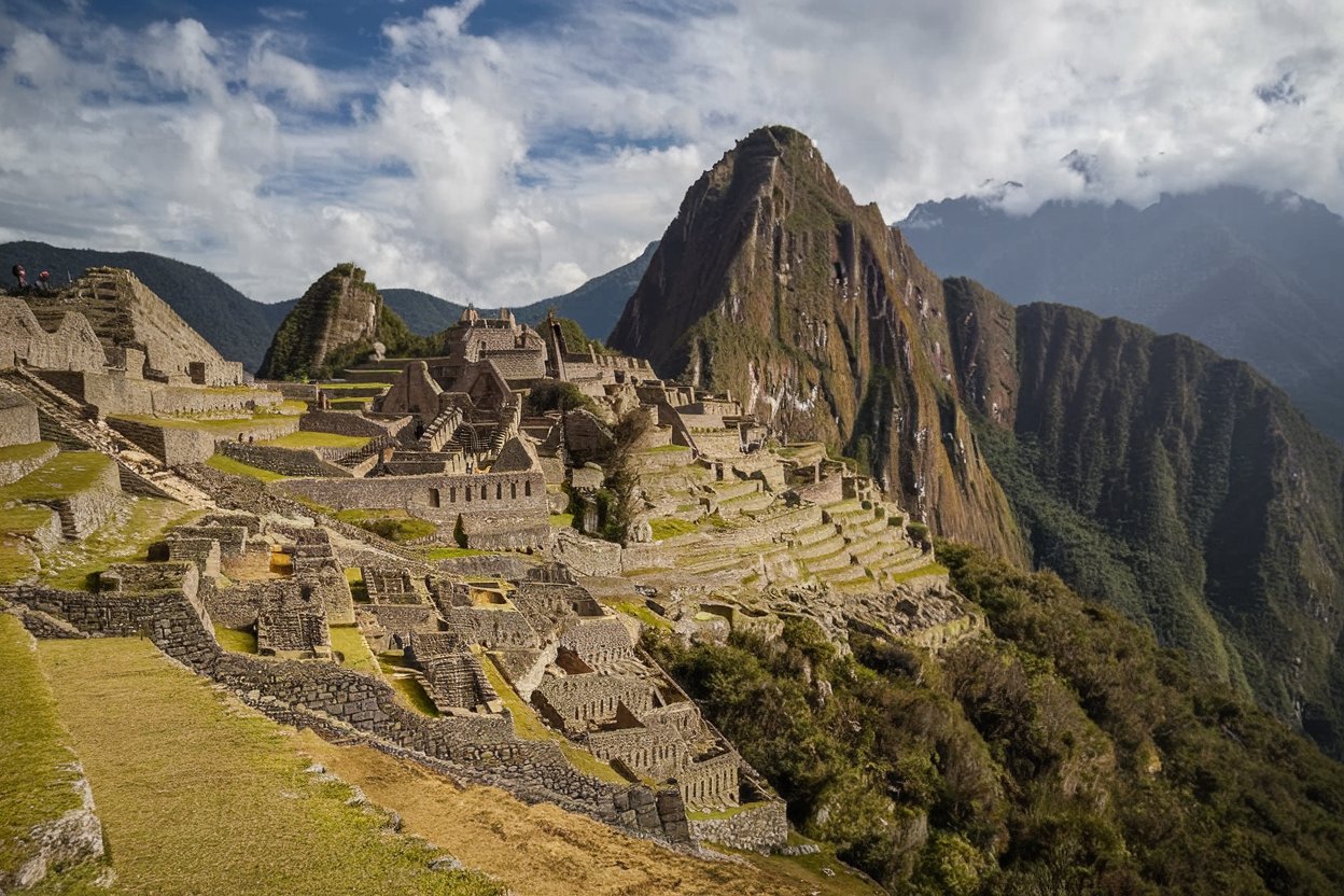 A hiker on the Inca Trail with ancient ruins and Andean peaks in the background, leading toward Machu Picchu.