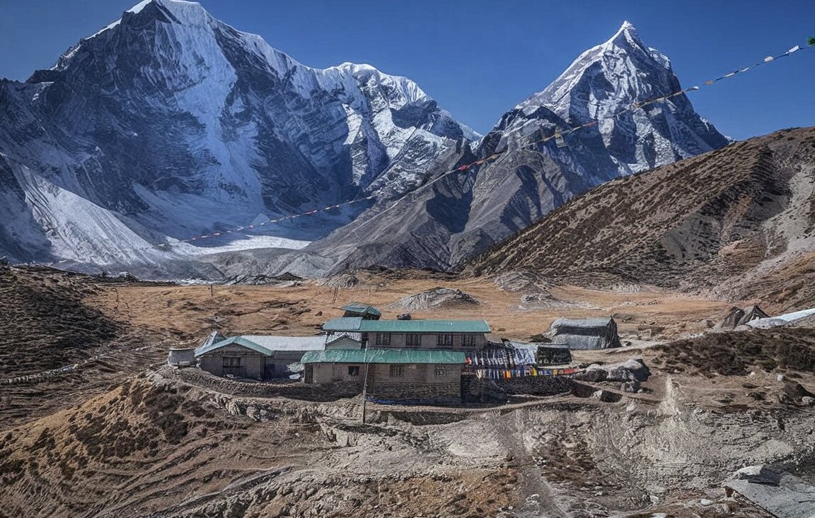 breathtaking mountainous landscape along the everest base camp trek in nepal, featuring towering snow-capped peaks, green-roofed structures, colorful prayer flags, rugged terrain, and patches of snow